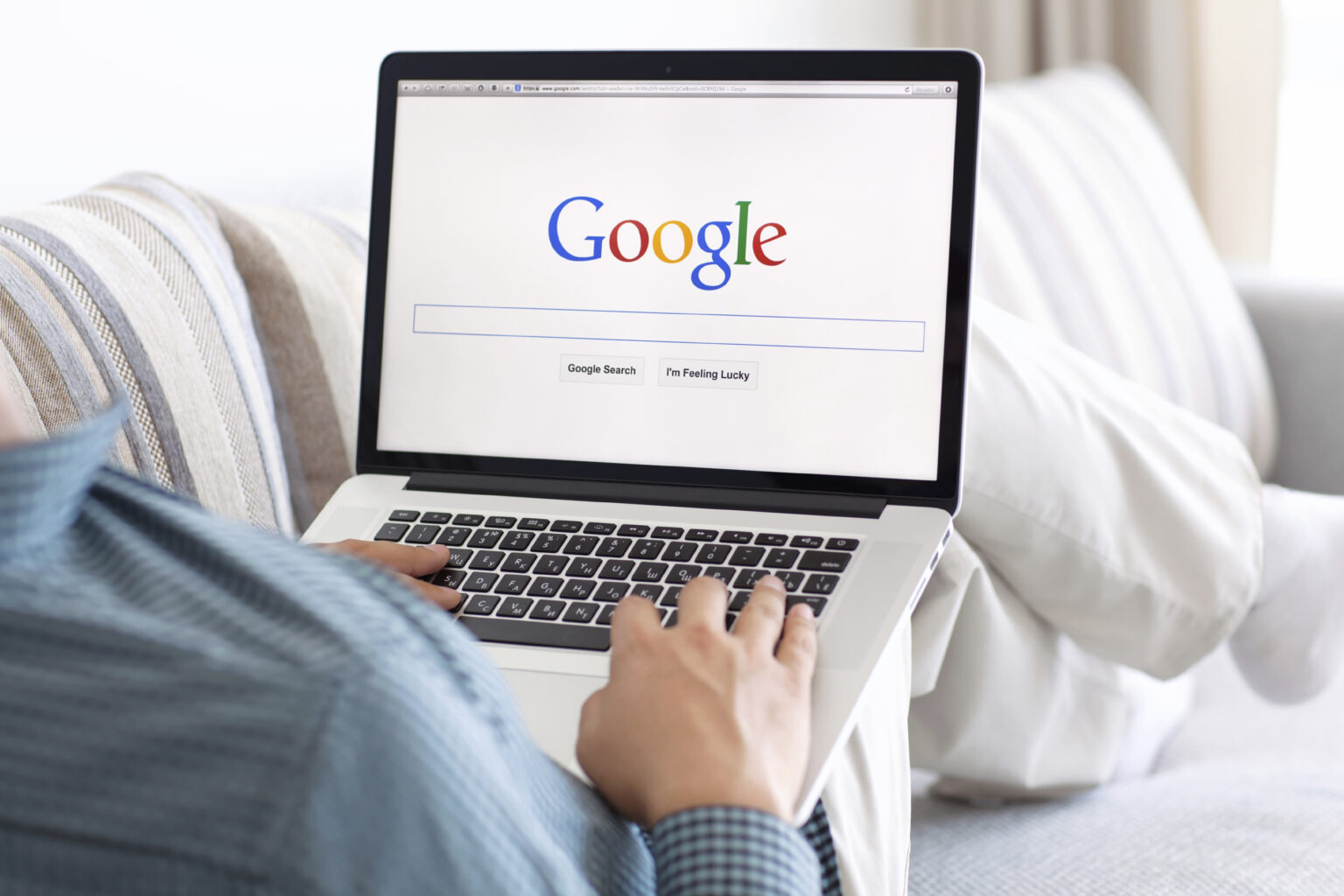 Person using a laptop with Google Search open on the screen