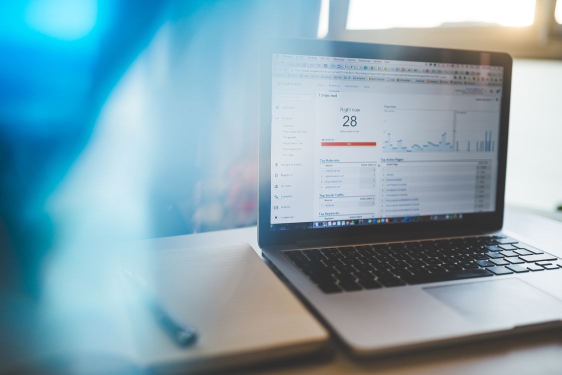Laptop displaying Google Analytics in a modern workspace for SEO analysis