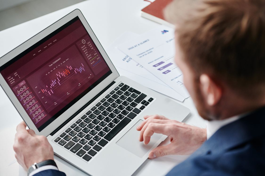 Professional reviewing analytics dashboard and growth data on laptop